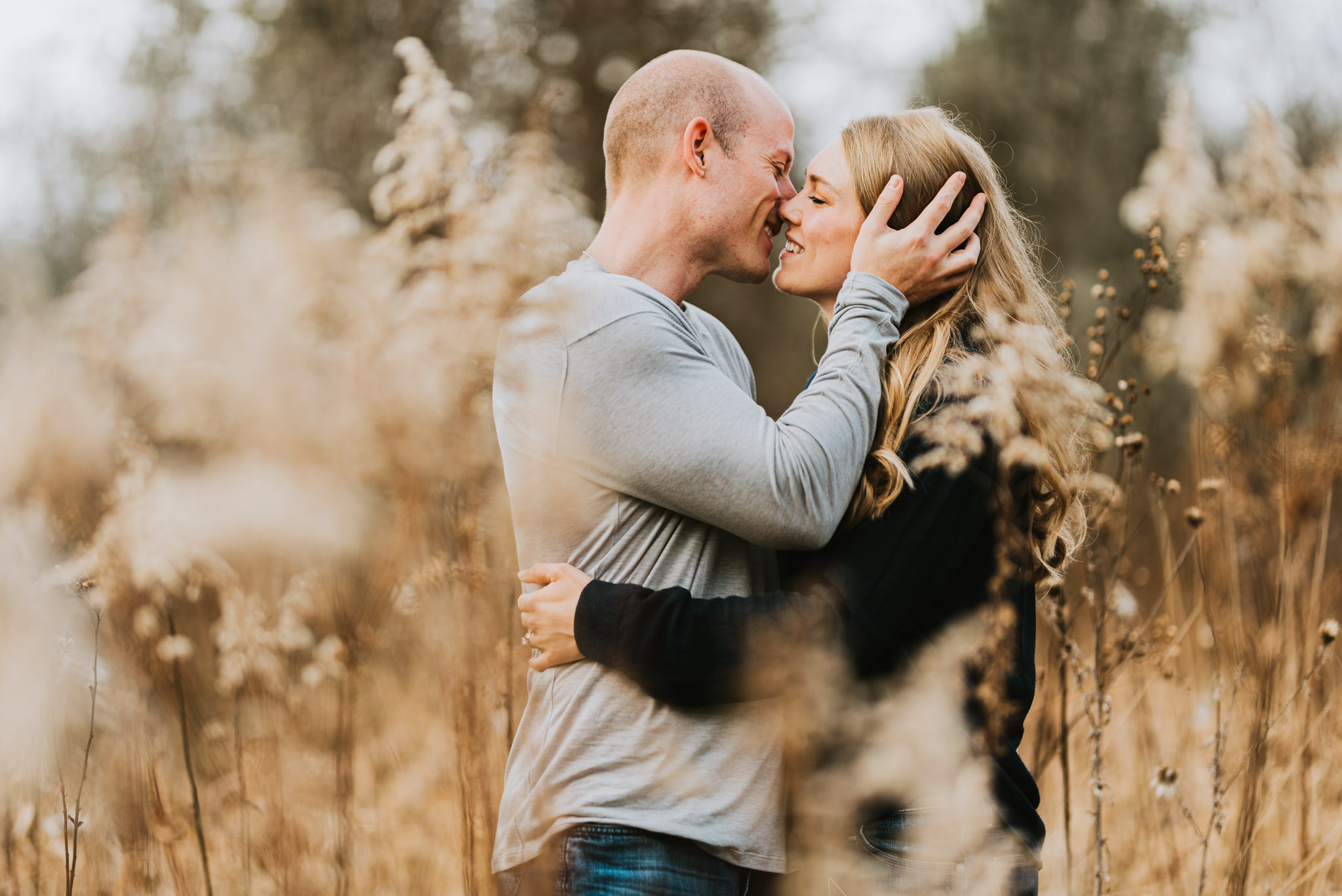 kissing in field fall engagement photo